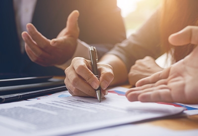 People signing paperwork